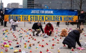 Schuman Roundabout in Brussels: Members from a U.S.-based nonprofit organization, Avaaz, protesting against the Russian abduction of Ukrainian children on Feb. 24, 2023. (Photo by Thierry Monasse)